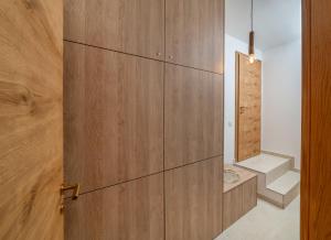 a room with a wooden wall with a staircase at Villa Rita Heritage Villas in Kaštela +44 photos