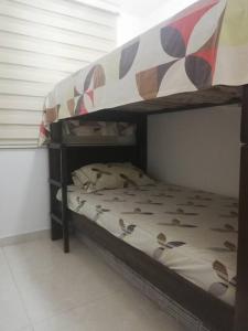 a bunk bed with a canopy in a room at Apartamento amoblado - Armenia Quindío. in Armenia