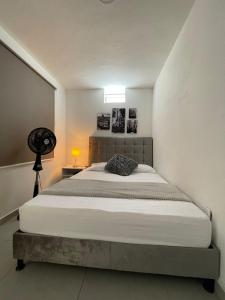 a bedroom with a large bed in a room at Hotel Boutique San Joaquin Plaza in Medellín