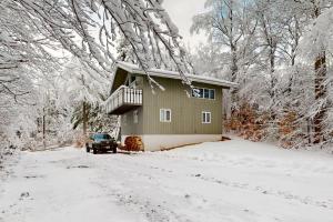 a house with a balcony in the snow at Everlasting Memories in Bartlett