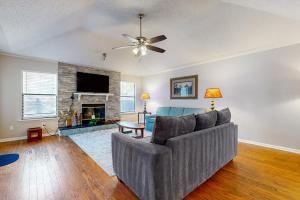 a living room with a couch and a fireplace at Hawks Hollow Hideaway in Jacksonville