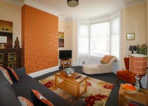 a living room with a couch and a table at The Regent Apartment 2 in Blackpool