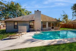 a house with a swimming pool in front of a house at Hawks Hollow Hideaway in Jacksonville