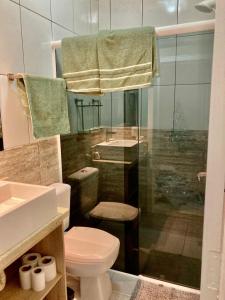 a bathroom with a toilet and a glass shower at Casa centro Falls in Foz do Iguaçu +22 photos
