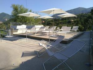 a group of chairs and umbrellas on a roof at Villanova Apartments - Nature & Wellness in Levanto