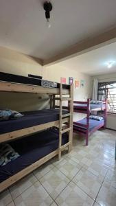 a group of bunk beds in a room at Fica, Vai ter Bolo Hostel in Itajaí