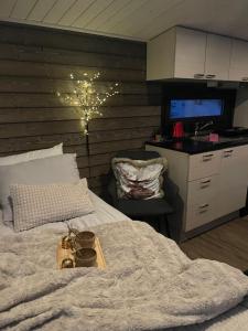 a bedroom with a bed with a tray on it at Tunnelmallinen ja ihana mökki in Rovaniemi