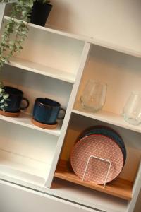 a shelf with cups and a bowl on it at Camden Studio in London
