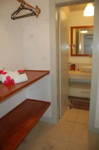 a bathroom with a counter and a sink and a mirror at Casa Vista Mar Itacaré in Itacaré