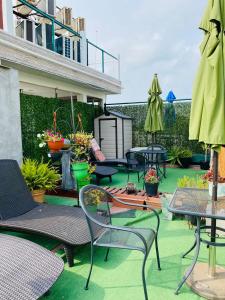 a patio with chairs and tables and umbrellas at Lilas del Mar Apartments in Playa del Carmen