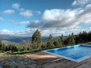 a swimming pool with a view of the mountains at Quinta das Mirandas Nature in Oliveira de Frades