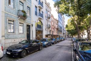 a row of cars parked on the side of a street at Akicity Saldanha White in Lisbon