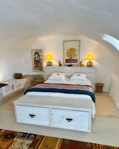 a bedroom with a white bed with two pillows at Guest App'Art in Tourrettes-sur-Loup