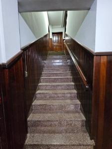 a stairway in a building with wooden walls and stairs at Apartamento bien localizado in Ciudad del Este
