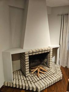 a brick fireplace with wooden logs in a room at Apartamento bien localizado in Ciudad del Este