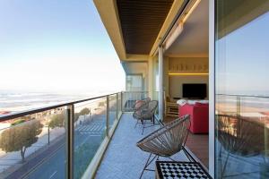 d'un balcon avec des chaises et une vue sur la plage. dans l'établissement Boutique Rentals- AL MAR Beachfront, à Póvoa de Varzim