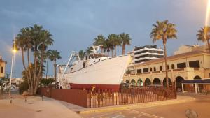 a boat on display in front of a building at Apartamento Pepi Puerto (Adults Only) in Santa Pola