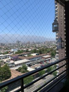 a view of a city from a balcony at Departamento Acogedor en Avenida Matta, a Pasos del Metro in Santiago