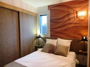 a bedroom with a bed with a large wooden wall at Le Logis de Bamby in Ancelle