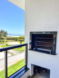 a fireplace in a room with a view of the ocean at Gamboa Luna y Sol Apart-Hotel in Gamboa