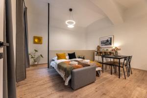a bedroom with a bed and a table and a desk at Eclectic and design duplex in Prague in Prague