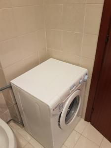 a washer and dryer in a bathroom at SANT'ALESSIO_BAY in Santa Margherita-Sant'Alessio Siculo