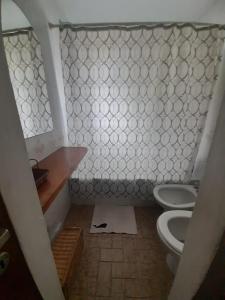 a bathroom with a toilet and a sink at La Casa de la Isla in San Martín de los Andes
