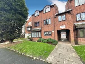 a large brick building with a garage and a driveway at 49 Saxon Mill, Tamworth in Tamworth