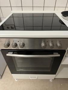 a stove top oven sitting in a kitchen at Wohnung mit Küche, Fernseher, WLAN und Parkplatz - Brian in Werne an der Lippe