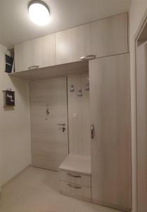 a room with a door and a wall with a counter at CITY POINT Apartment in Podgorica