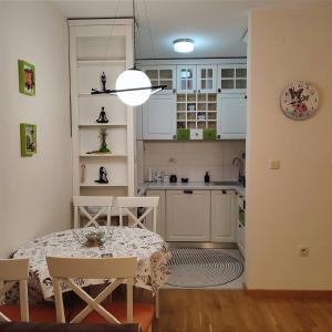 a kitchen and dining room with a table and chairs at CITY POINT Apartment in Podgorica
