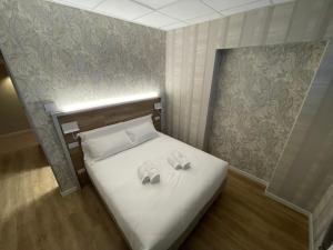 1 dormitorio con 1 cama con 2 toallas en ROME'S GLORIA HOTEL, en Roma