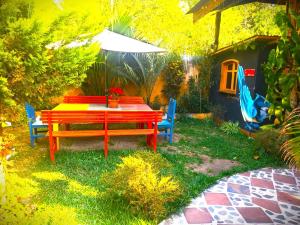 a colorful table and chairs in a yard at Art & Coffee in Santa Cruz La Laguna