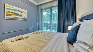 Postel nebo postele na pokoji v ubytování Rezydencja Niechorze 124 - 5D Apartamenty