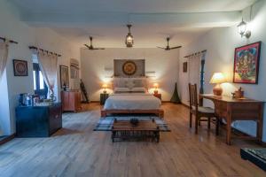a bedroom with a bed and a table in it at Samsara Apartments by Baber Mahal Revisited in Kathmandu