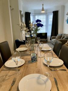 a wooden table with plates and wine glasses on it at Fairfax in Southend-on-Sea