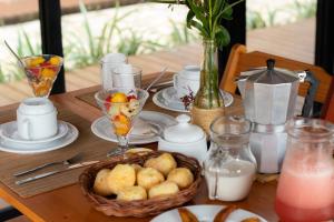 a table with plates of food and a basket of food at Barong EcoVilla in Barra Grande
