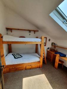 a bedroom with two bunk beds in a attic at Appartamento Belvedere in Frabosa Soprana