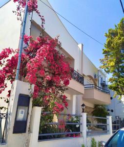 a building with pink flowers on the side of it at Seaside Villa for 6 people - Alykes Beach in Dhimínion