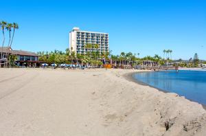 une vue d'une plage avec un bâtiment en arrière-plan dans l'établissement Mission Bay Cottage - Bay View Patio, Parking, WasherDryer, à San Diego