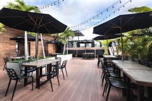 a row of tables and chairs with umbrellas on a patio at Hotel Cartagena DC in Cartagena de Indias