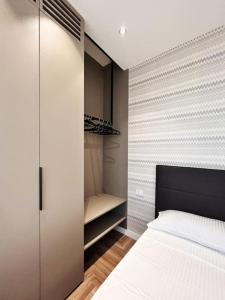 a bedroom with a bed and a walk in closet at YLS Luxury Suites 2 in Milan