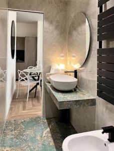 a bathroom with a sink and a large mirror at YLS Luxury Suites 2 in Milan