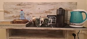 a shelf with cups and utensils on it at B&B Monastero in Dubino