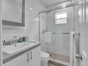 a bathroom with a shower and a sink and a toilet at Coastal Charm Studio Retreat near Pompano Beach in Pompano Beach +6 photos