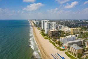 an aerial view of a beach with buildings and the ocean at Coastal Charm Studio Retreat near Pompano Beach in Pompano Beach