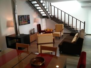 a living room filled with furniture and a staircase at Solar Guesthouse Olival da Vinha in Castelo de Paiva