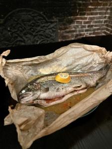 a fish in a paper bag with a lemon on it at Scole Inn Hotel in Diss