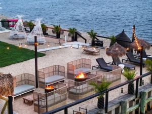 an aerial view of a patio with chairs and fires at Aqua by American Beech - Adults Only in Aquebogue
