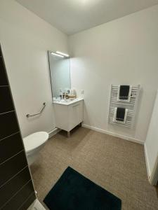 a bathroom with a toilet and a sink and a mirror at Zenao Appart'hôtels Boulogne-sur-Mer - La Rose des Vents in Boulogne-sur-Mer